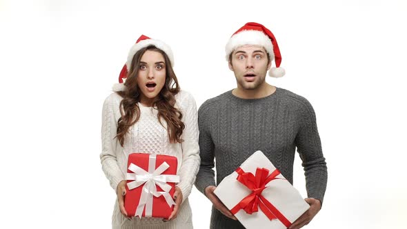 Slow Motion Young Couple Surprisingly Shock in Sweater and Christmas Hat Celebrate for Christmas Day