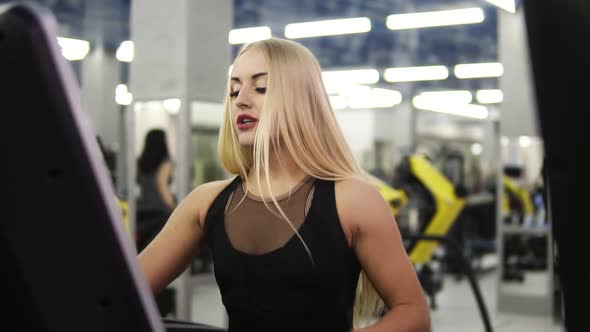 Young Attractive Blond Caucasian Woman with Piercing in Black Sport Outfit Breathing Intensly While