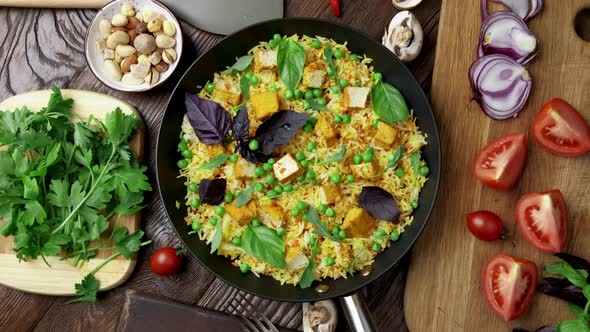 Vegetable Rice with Green Peas Carrots Tofu and Mushrooms on Wooden Background