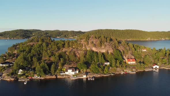 Beautiful Norwegian island fishing village cabins at sunset, aerial panoramic