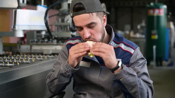 A young man takes food at workplace during work hours or during his lunch break