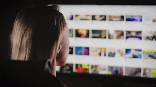 A Woman Chooses a Video to Watch