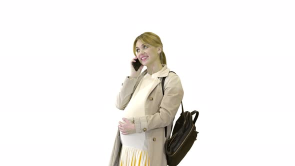 Pregnant Woman in a Cloak with Backpack Talking on the Phone on White Background.