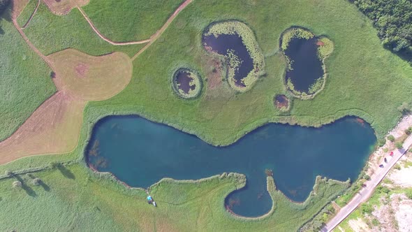 Aerial view of lakes on a grass meadow