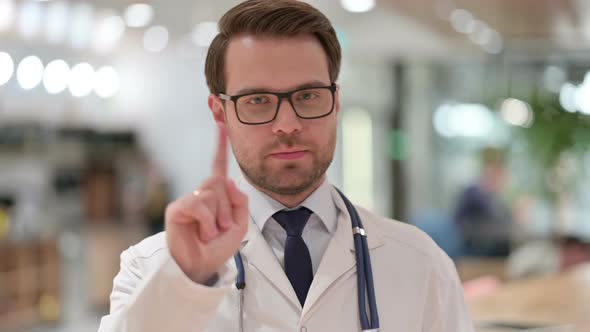 Portrait of Male Doctor with No Sign By Finger 