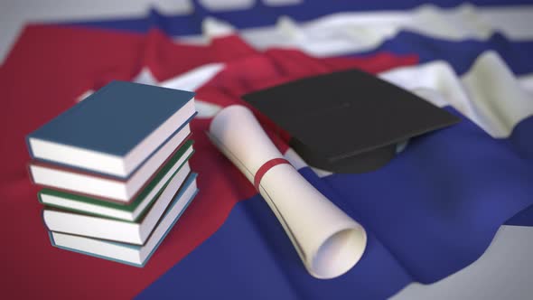 Graduation Cap Books and Diploma on the Cuban Flag