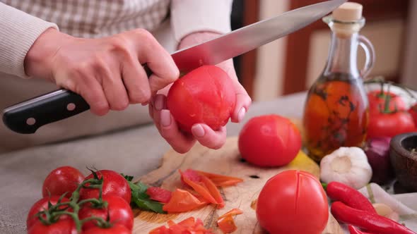 Woman Peels a Tomato Peel By Knife at Domestic Kitchen