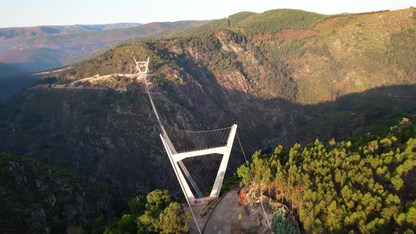 Suspension Bridge through Mountain River