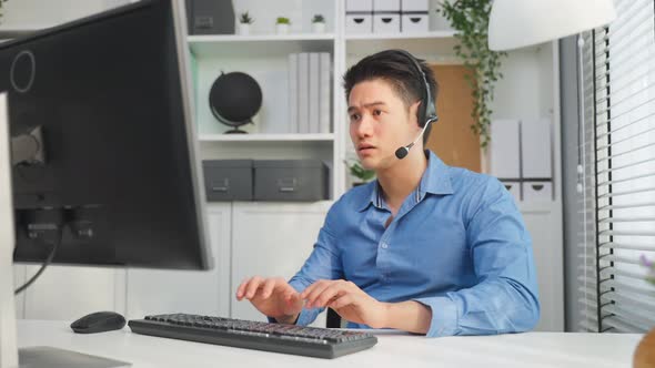 Asian businessman use laptop computer video call with office colleagues.