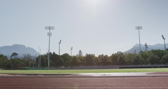 Disabled mixed race man with prosthetic legs running on race track