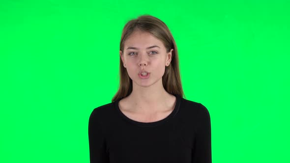 Young Woman Talks About Something Then Making a Hush Gesture, Secret. Green Screen
