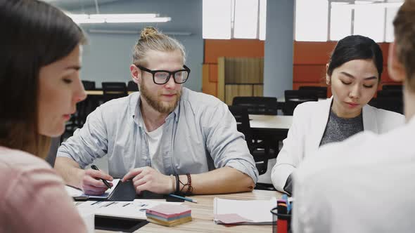 Young Team of Multiracial Diverse Colleagues Developing Strategy for Startup Project During