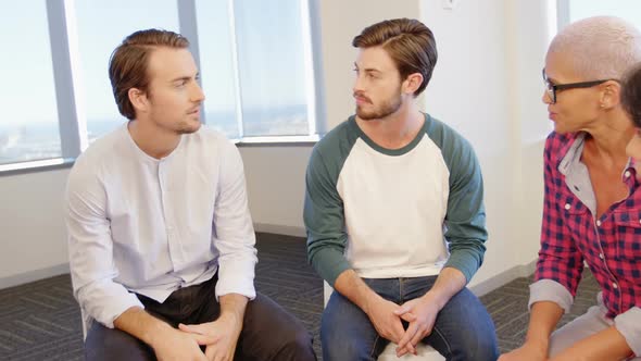 Creative business team consoling upset colleague