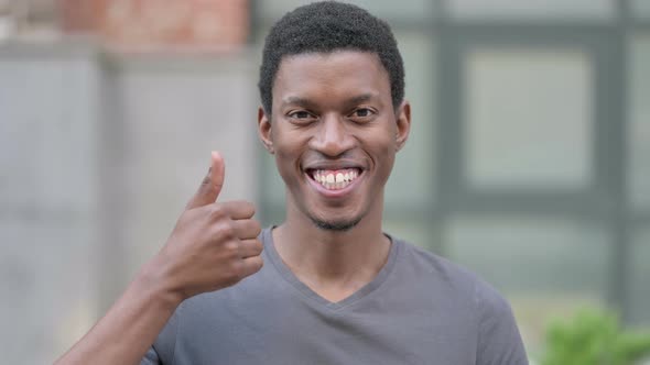 Portrait of Positive Young African Man Doing Thumbs Up