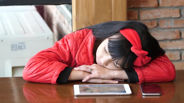 Child Bored With Tablet And Phone