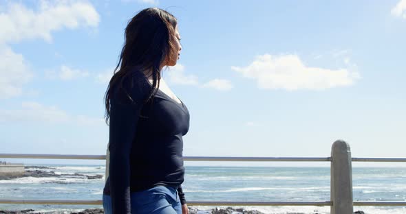 Side view of disabled woman walking on promenade near railing 4k