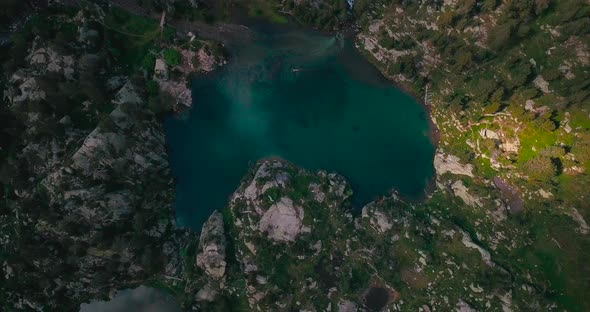 Aerial vertical 4K footage of two lakes in a green natural environment in the Spanish Pyrenees.