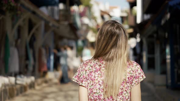 Girl Wondering Around Old Town with Shop's Showcases