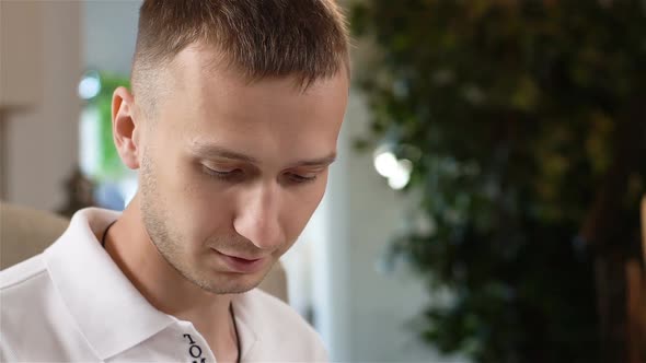 Closeup Guy Sits at Table in Restaurant Ordering Meals