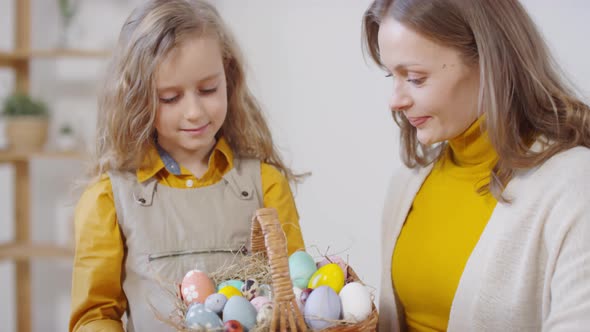Happy Woman and Girl Posing with Easter Eggs