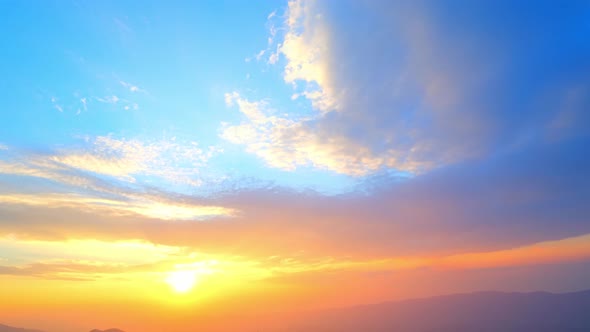 4K : Timelapse of clouds moving at sunset over beautiful mountains.