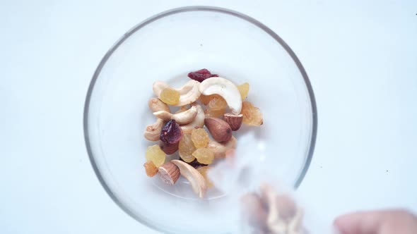 Close Up of Many Mixed Nuts Pouring in a Bowl