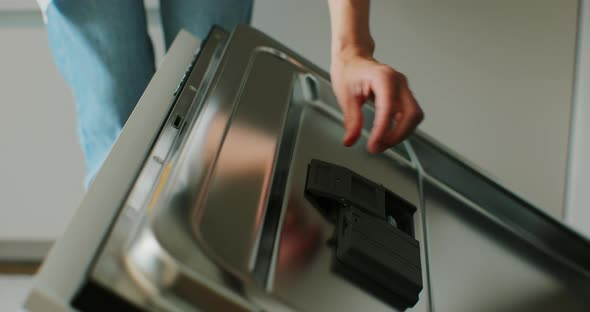 Woman Adding Rinse Aid Tablets Detergent