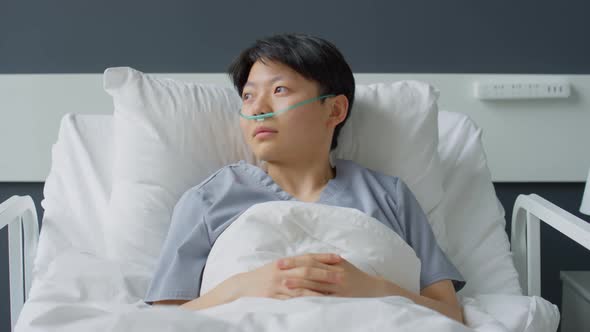 Portrait of Asian Woman with Nasal Cannula in Hospital