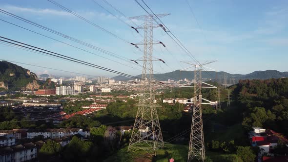 Aerial view ascending up electric tower