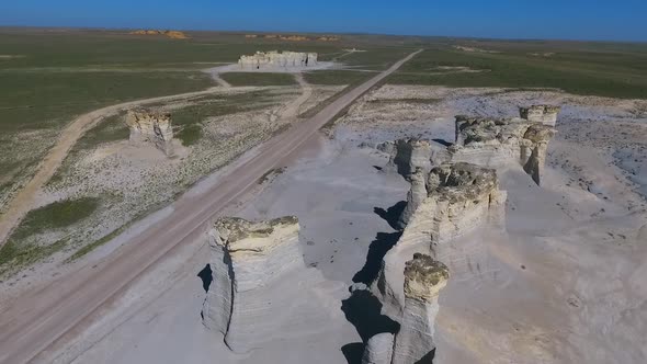 Aerial Along Desert Rock Formations By Road in Kansas