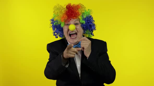 Senior Old Woman Clown in Colorful Wig Smiling, Fool Around, Laughing. Halloween