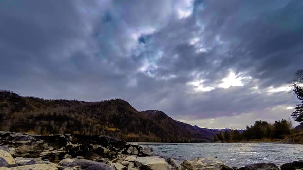 Time Lapse Shot of a River Near Mountain Forest. Huge Rocks and Fast Clouds Movenings. Horizontal