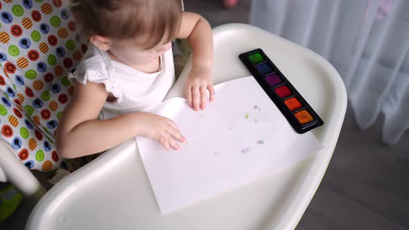 Cute Little Girl Painting with Fingers at Home