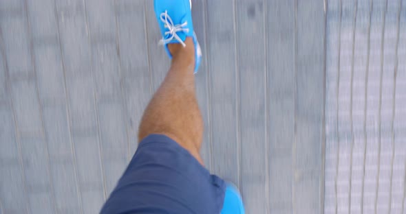 Man walking down the street in blue moccasins