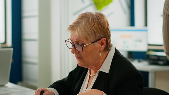 Portrait of Senior Businesswoman Looking at Camera