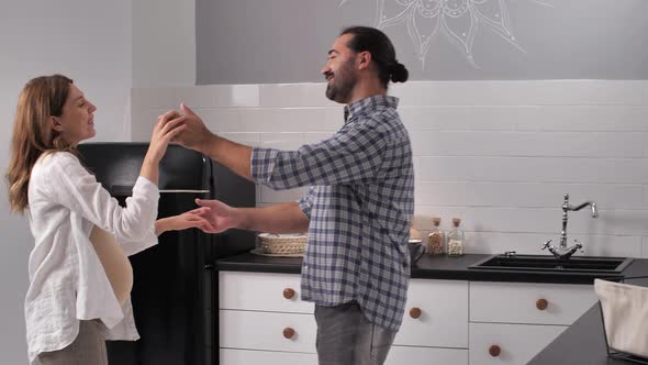 Happy Future Parents Dancing at Home