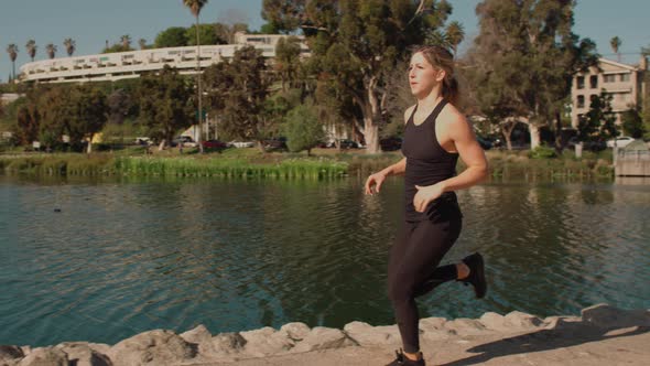 Very Athlete Woman Works Out In The Park