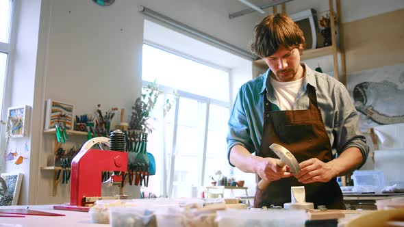 Young man working with mosaic