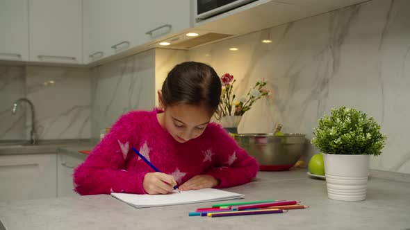Charming Preteen Girl Drawing Sketchbook with Colorful Pencils at Home