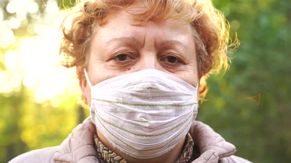 Mature Woman in Mask in Park