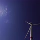 Blades of a Large Wind Turbine in a Field Against a Background of Cloudy Blue Sky on the Horizon - VideoHive Item for Sale
