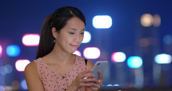 Woman use mobile phone at night