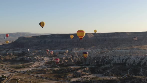 Hot air balloons flying over the valleys of Cappadocia near Goreme, Turkey