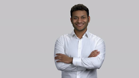 Happy Cheerful Hindu Man with Folded Arms Pointing Left with His Finger