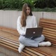 Young Female in Garden Using Laptop Communicates on Internet with Customer - VideoHive Item for Sale