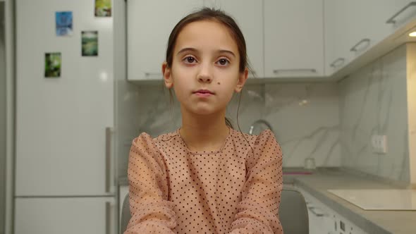 Portrait of Lovely Preteen Girl Expressing Sadness or Boredom Indoors