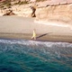 Aerial Drone Footage of a Girl Walking Along a Lonely Beach - VideoHive Item for Sale