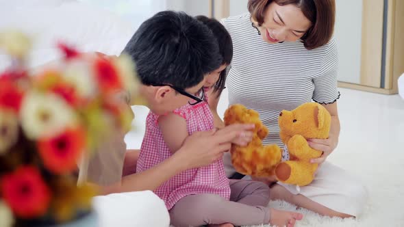 Happy family with mother, father and disabled daughter spending time together at home.