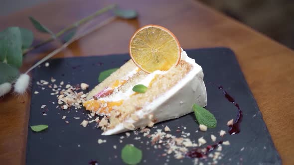 Close-up of cake with peaches on a stone board