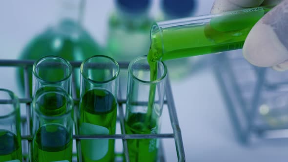 Scientist is preparation the green chemical solution in test tube in the laboratory experiment.